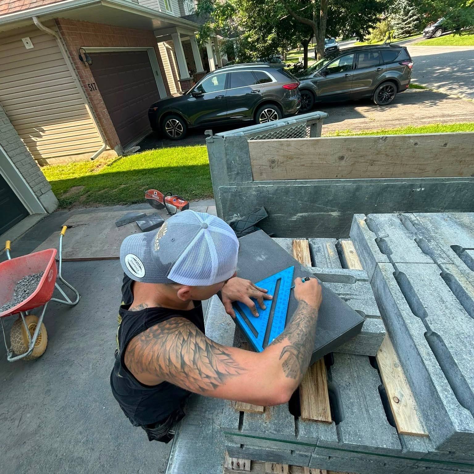 The owner of Gonzo Construction measuring stone on a job site in Kingston, Ontario