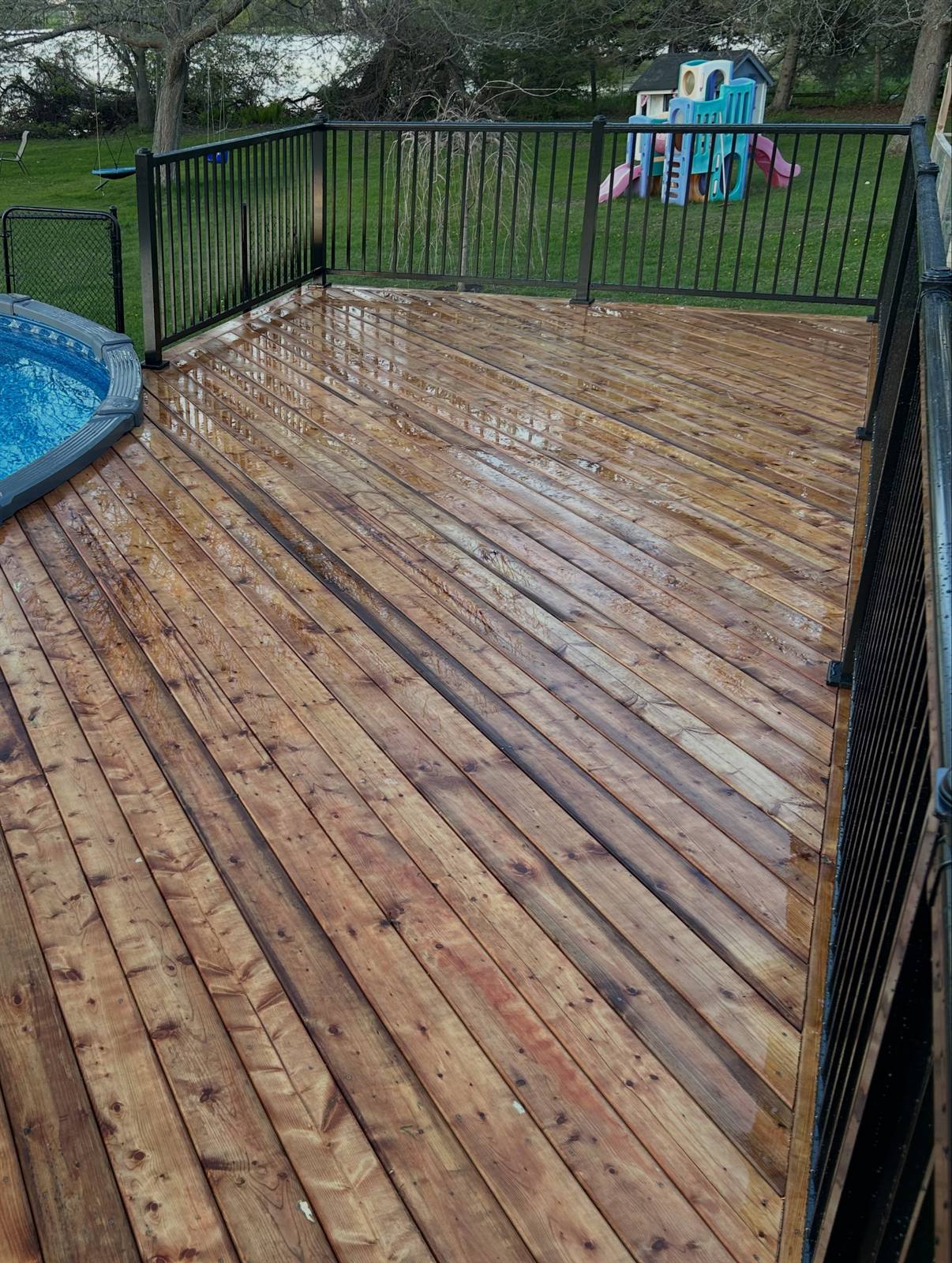 Wood pool deck with aluminum railing built by Gonzo Construction in the Kingston area