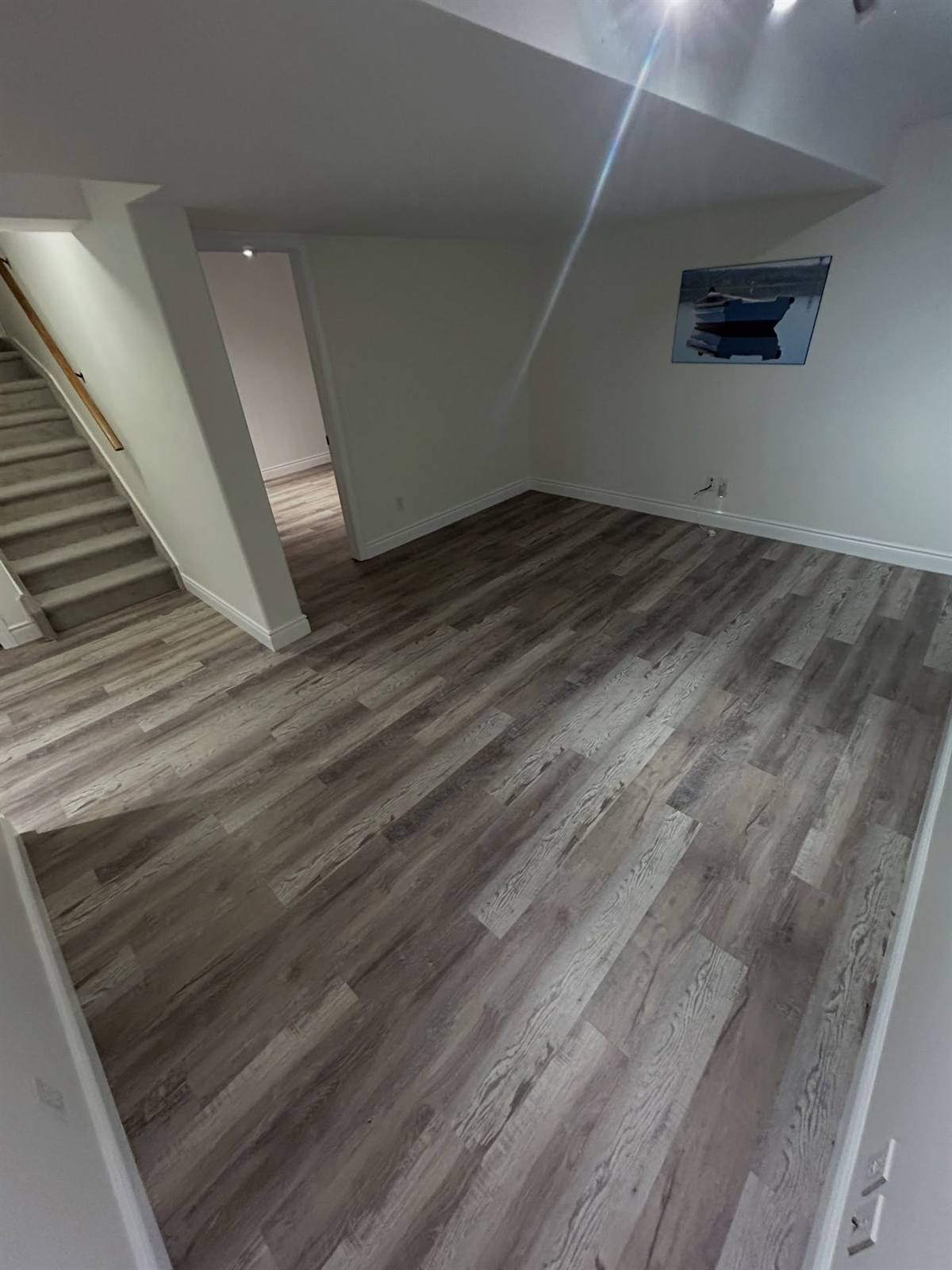 Finished basement renovation with new flooring in the Kingston area